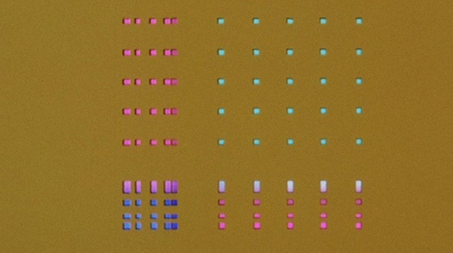 A series of pink, green, white, lilac and blue oblongs and squares on a tan background.